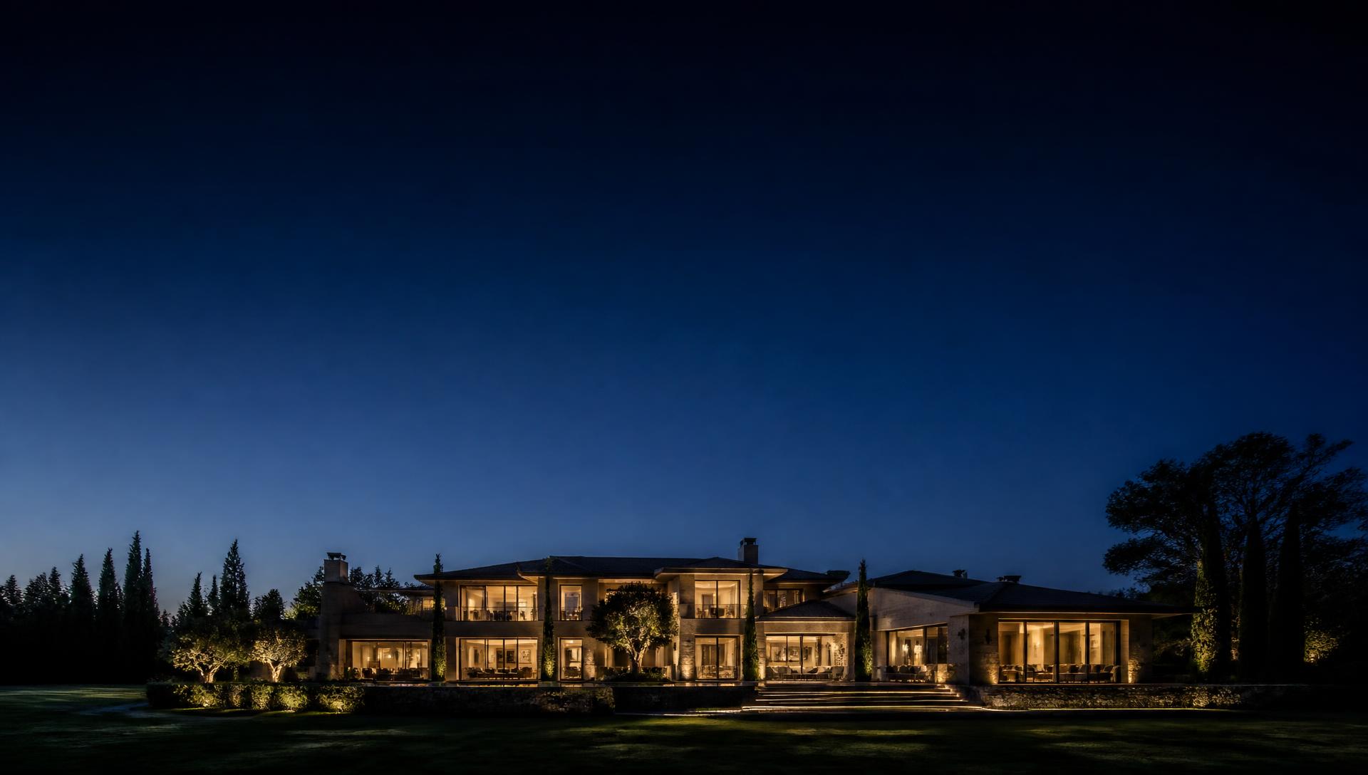 Luxury estate home illuminated at dusk